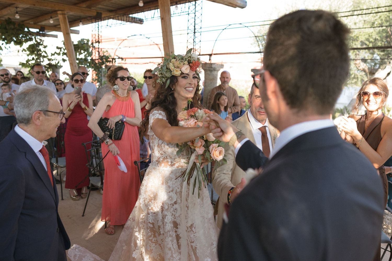 Wedding guests enjoying a lively celebration under string lights at an outdoor venue.