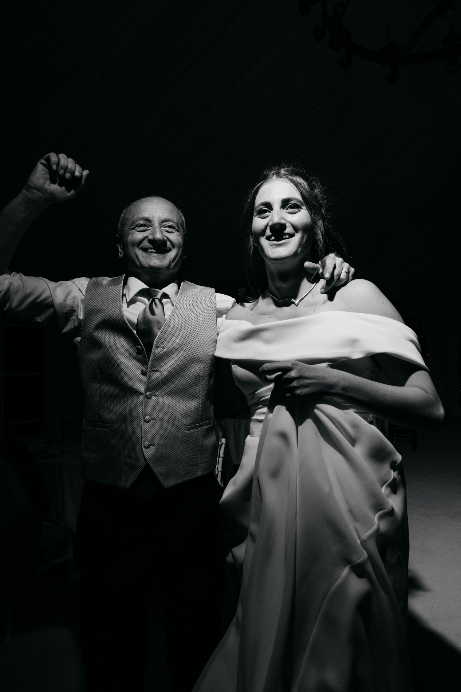 A joyful celebration captured in black and white showing dancing and excitement.