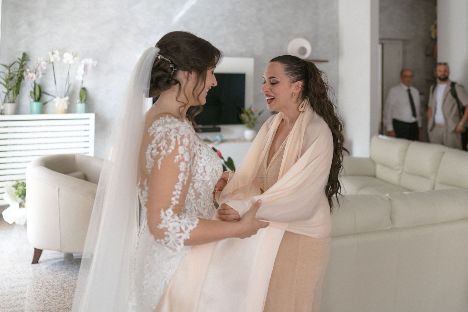 Joyful preparations take place in a bright white room with mirrors and natural light.