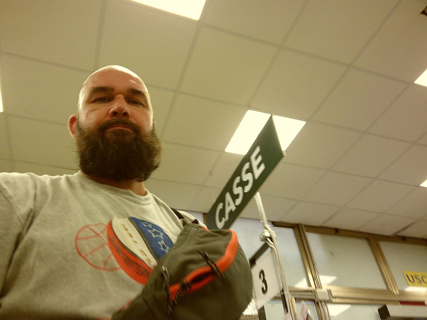 Low angle shot in an indoor facility with fluorescent lighting and directional signage.
