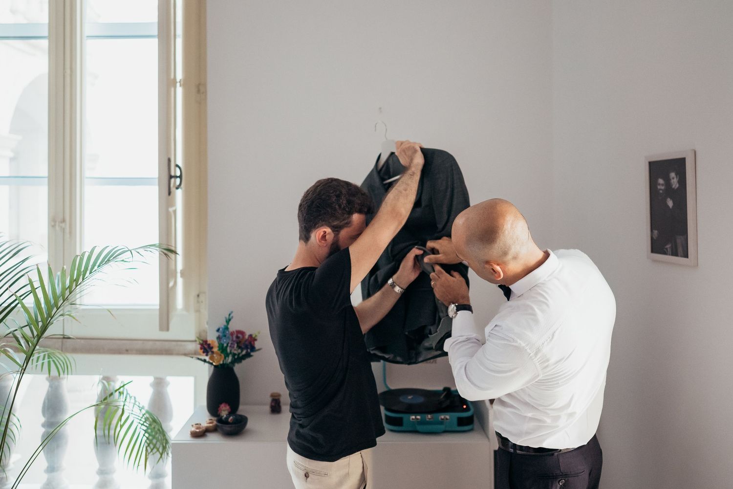 People working with photography equipment in bright interior space.