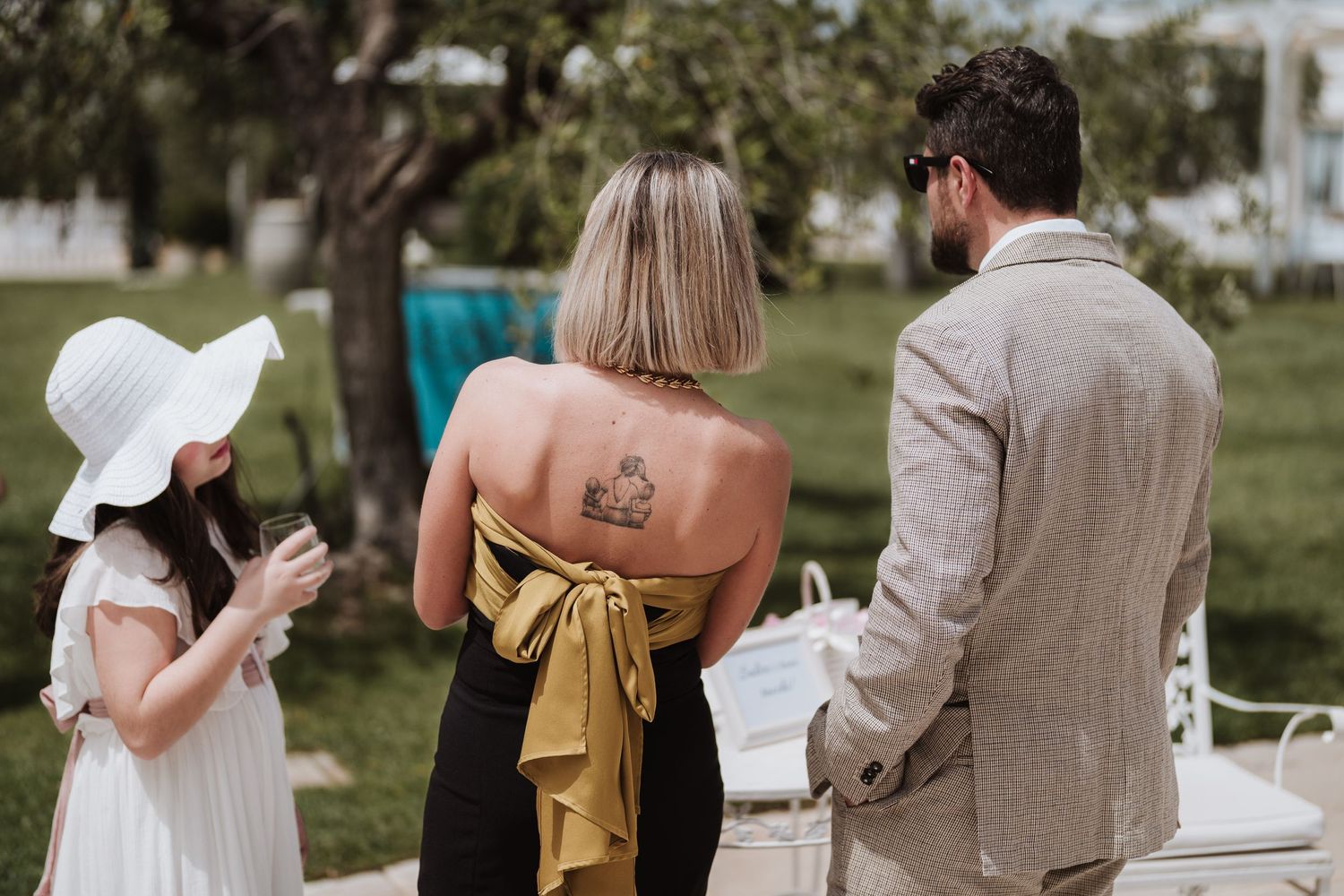 Wedding guests mingling outdoors during a garden reception.