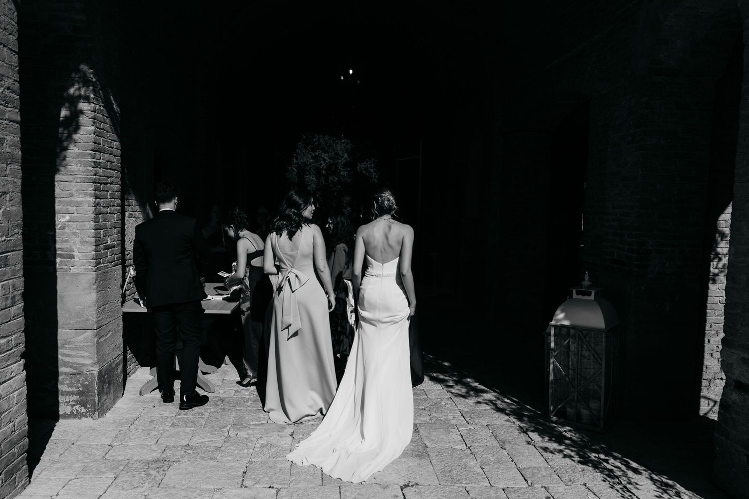 Black and white panoramic photograph of a formal event with guests in elegant attire.