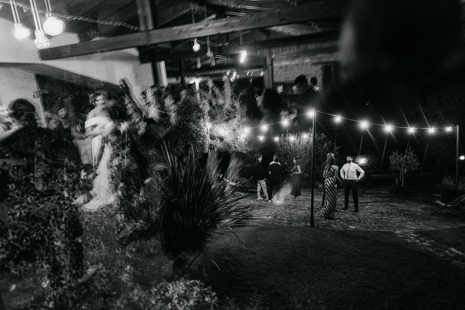 Nighttime outdoor event setting with string lights creating a warm ambiance.