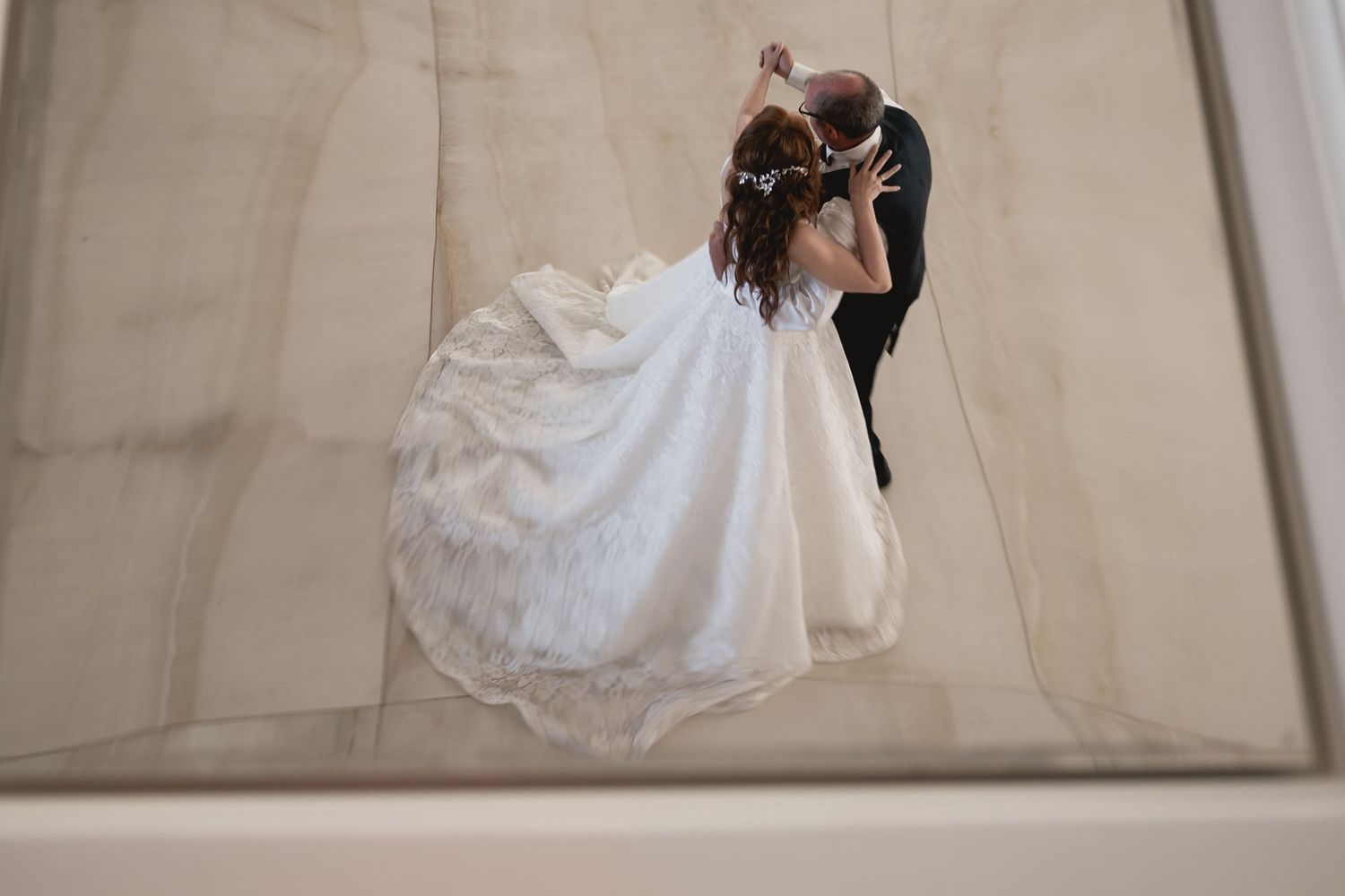 Artistic overhead view of a couple dancing in formal attire.