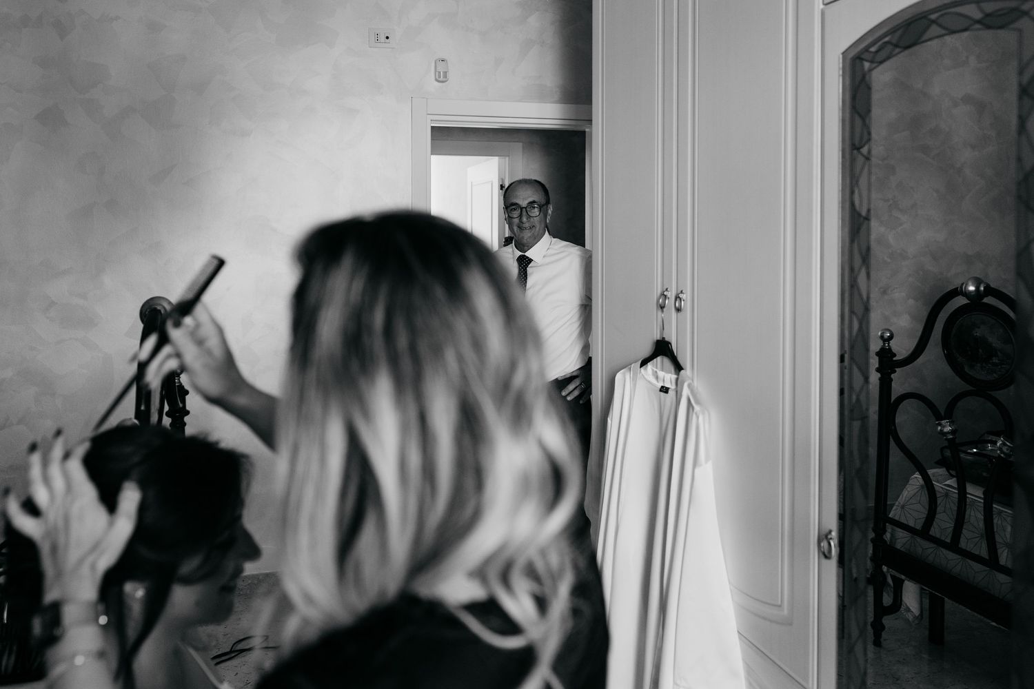 A black and white photo collage showing a person looking through a doorway in multiple sequential frames.