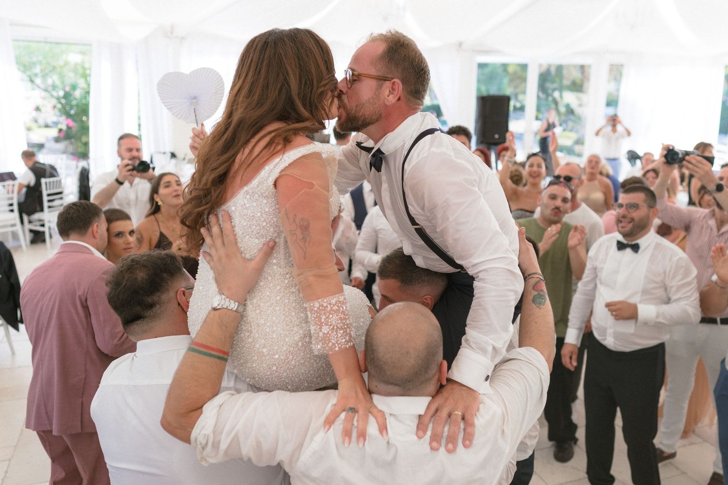 Wedding reception dance floor moments captured in sequence under white tent lighting.