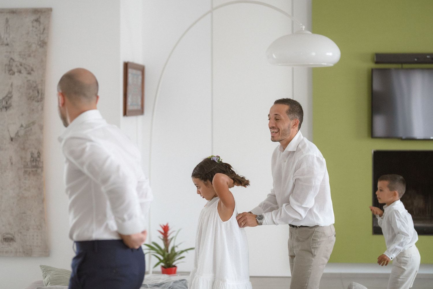Wedding party preparations taking place in a bright room with white and lime green walls.