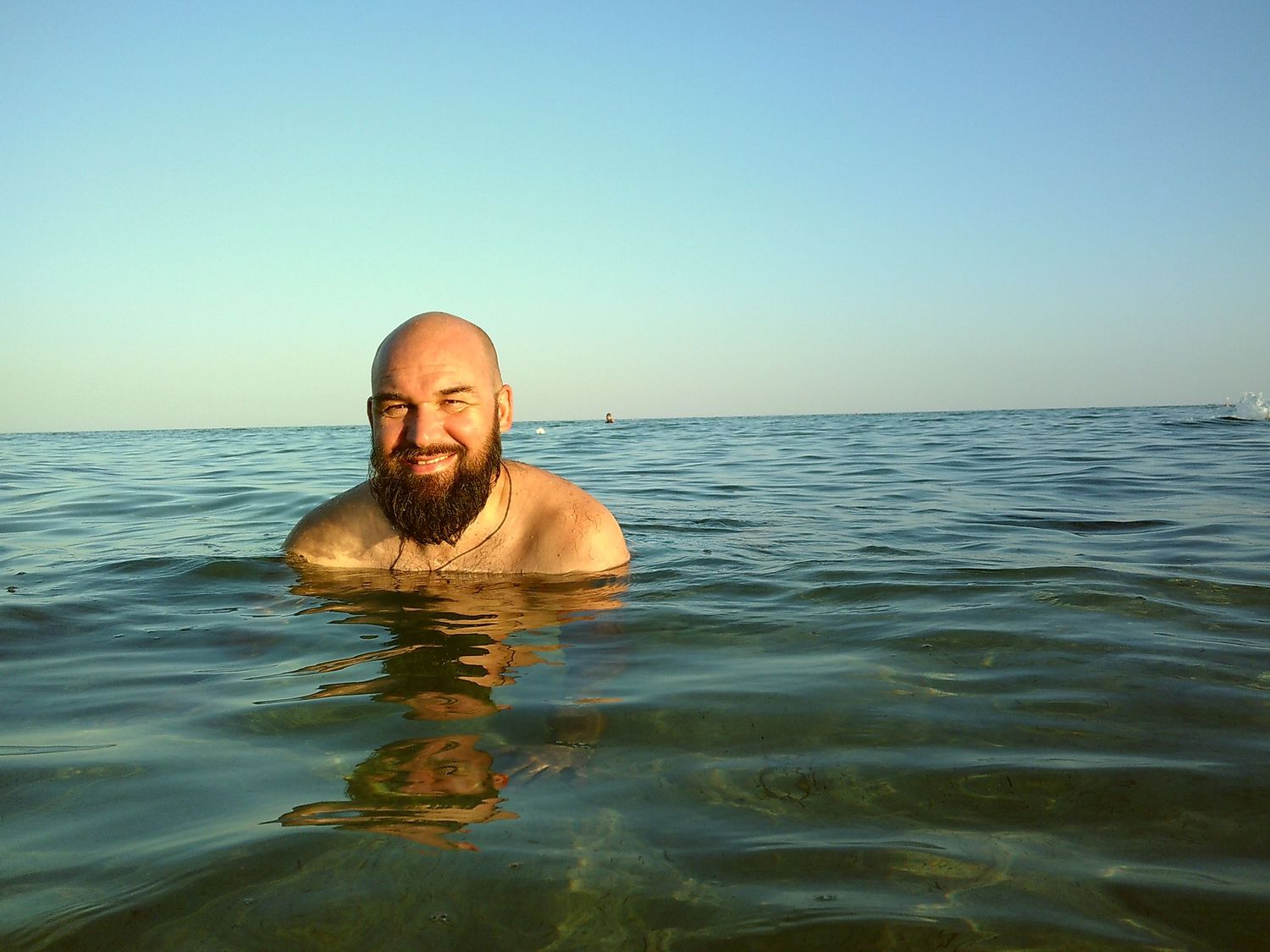 A swimmer enjoying the calm ocean waters on a clear day.