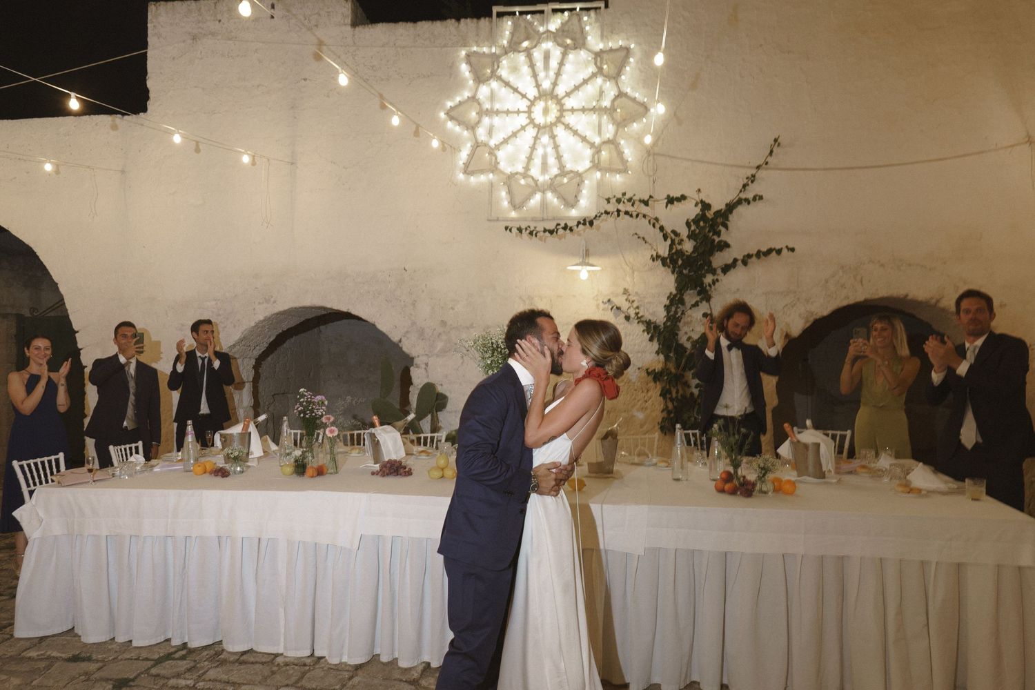 Reception venue features large illuminated snowflake decoration above dance floor during first dance.