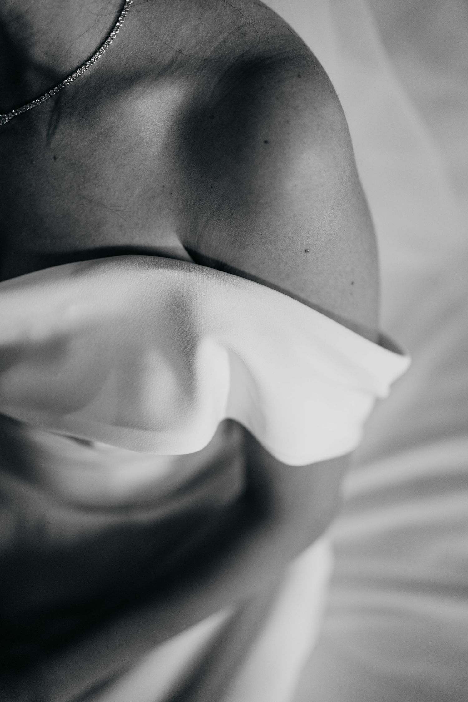 Abstract black and white macro photography of fabric folds and textures.