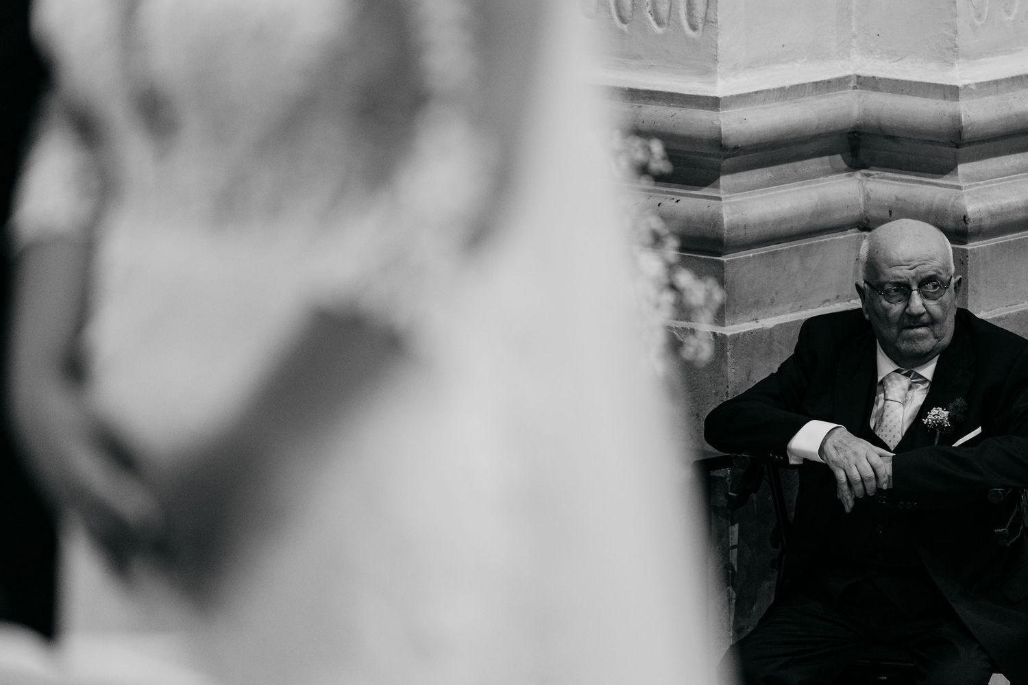 Candid moments during a wedding ceremony photographed in black and white.