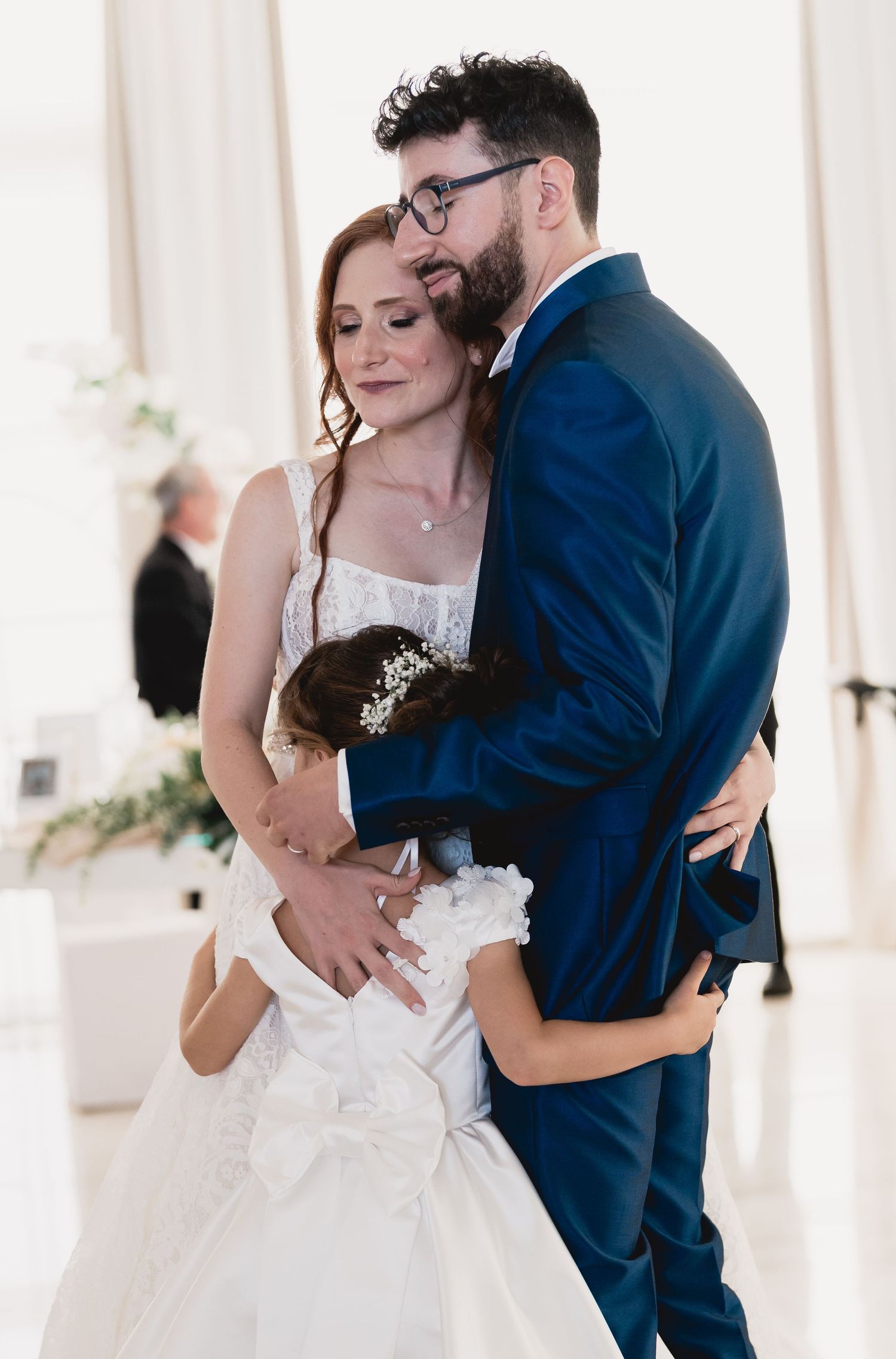 Intimate wedding moment captured as couple embraces during their celebration.