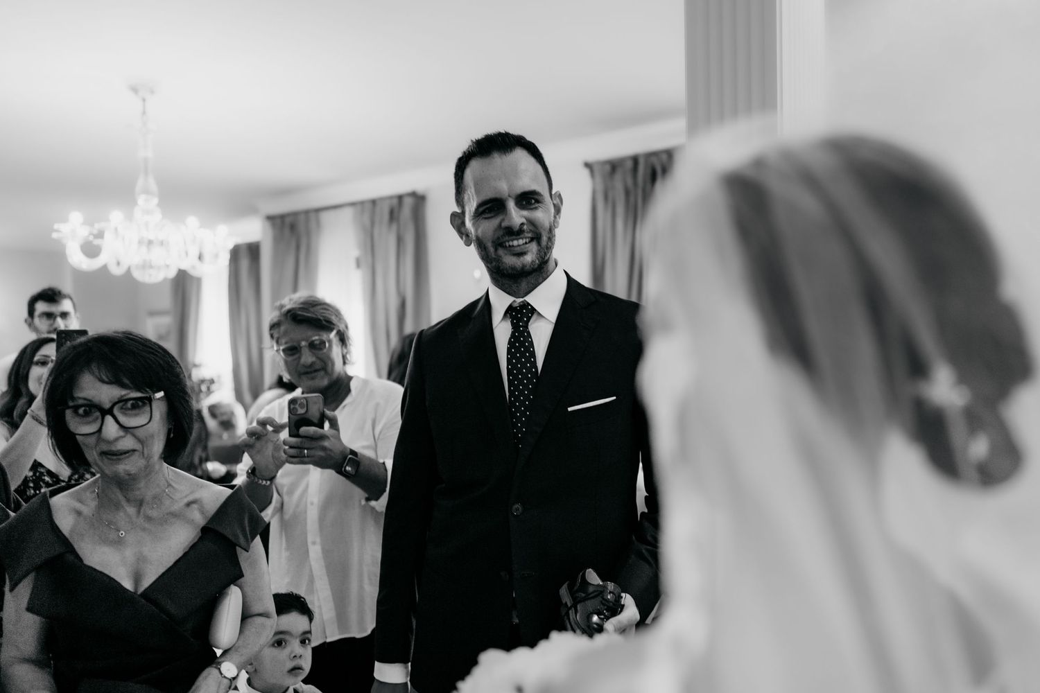 A candid wedding ceremony moment captured in black and white photography.