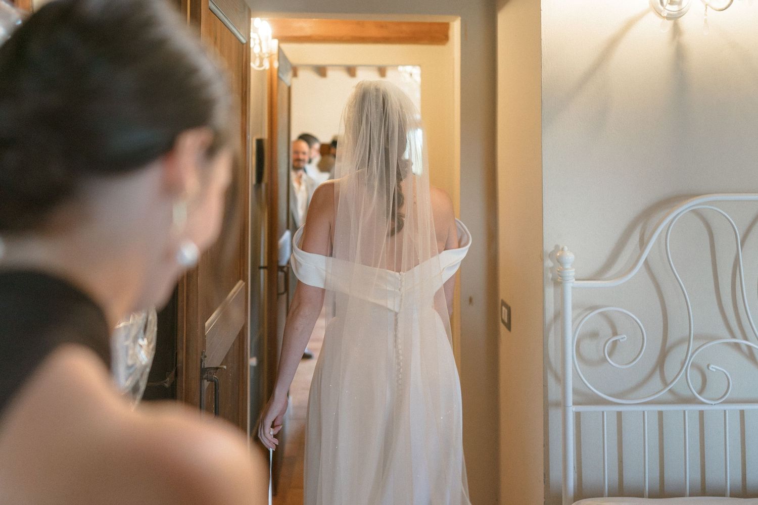 Interior scene showing elegant white wedding dress details and decor.