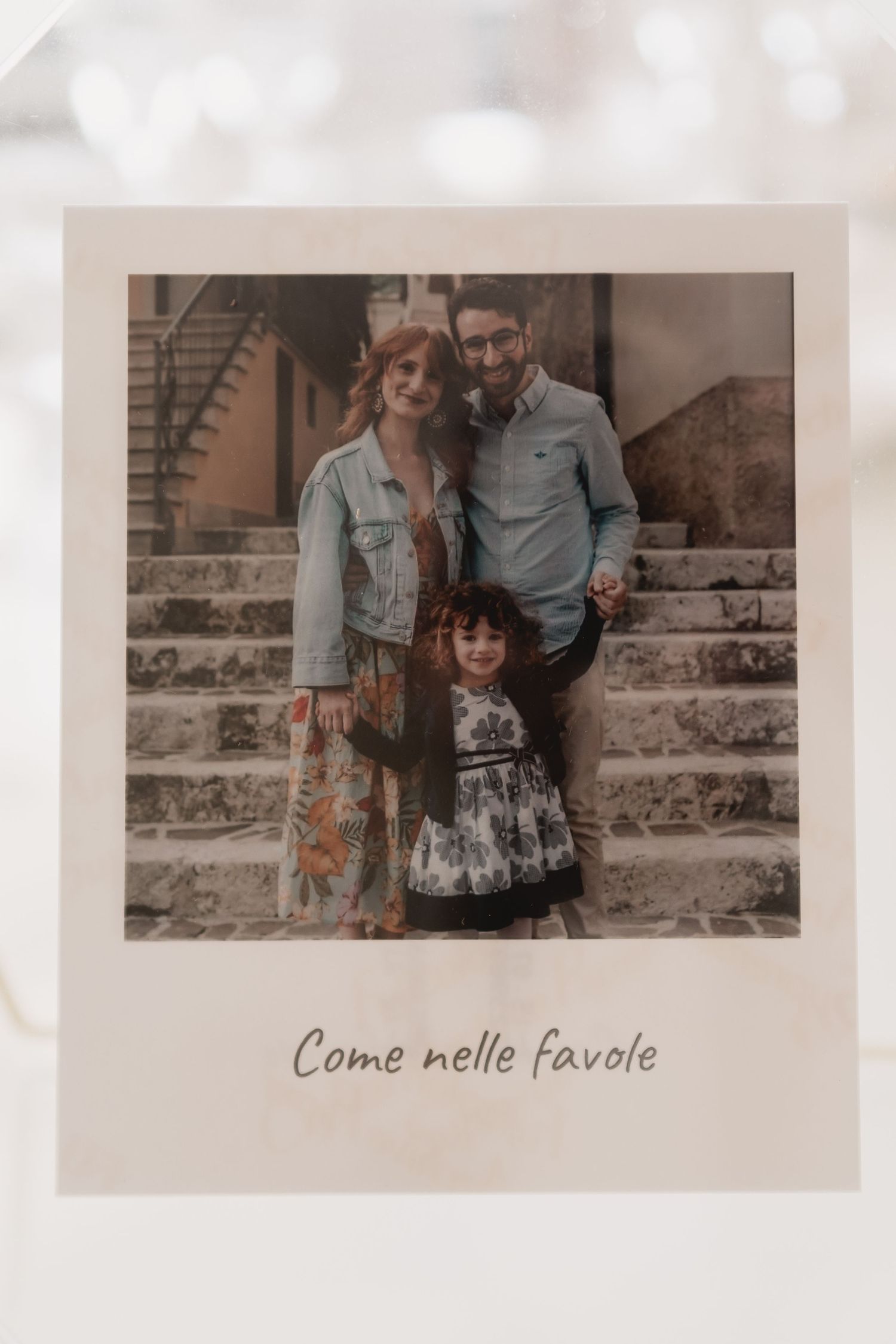 Vintage-style polaroid photo with Italian text 'Come nelle favole' at bottom.