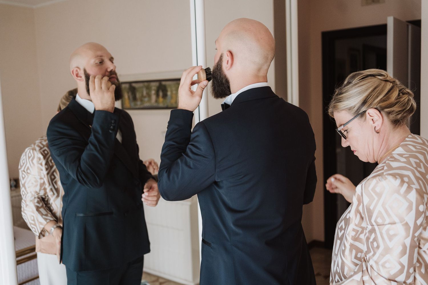 Candid getting ready moment with preparations for formal event.