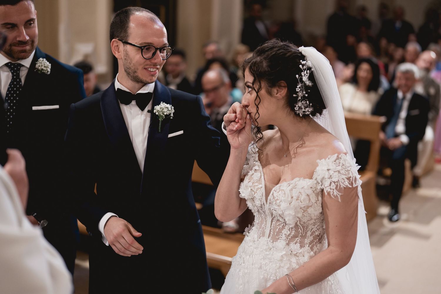 Emotional exchange during a Catholic church wedding ceremony.