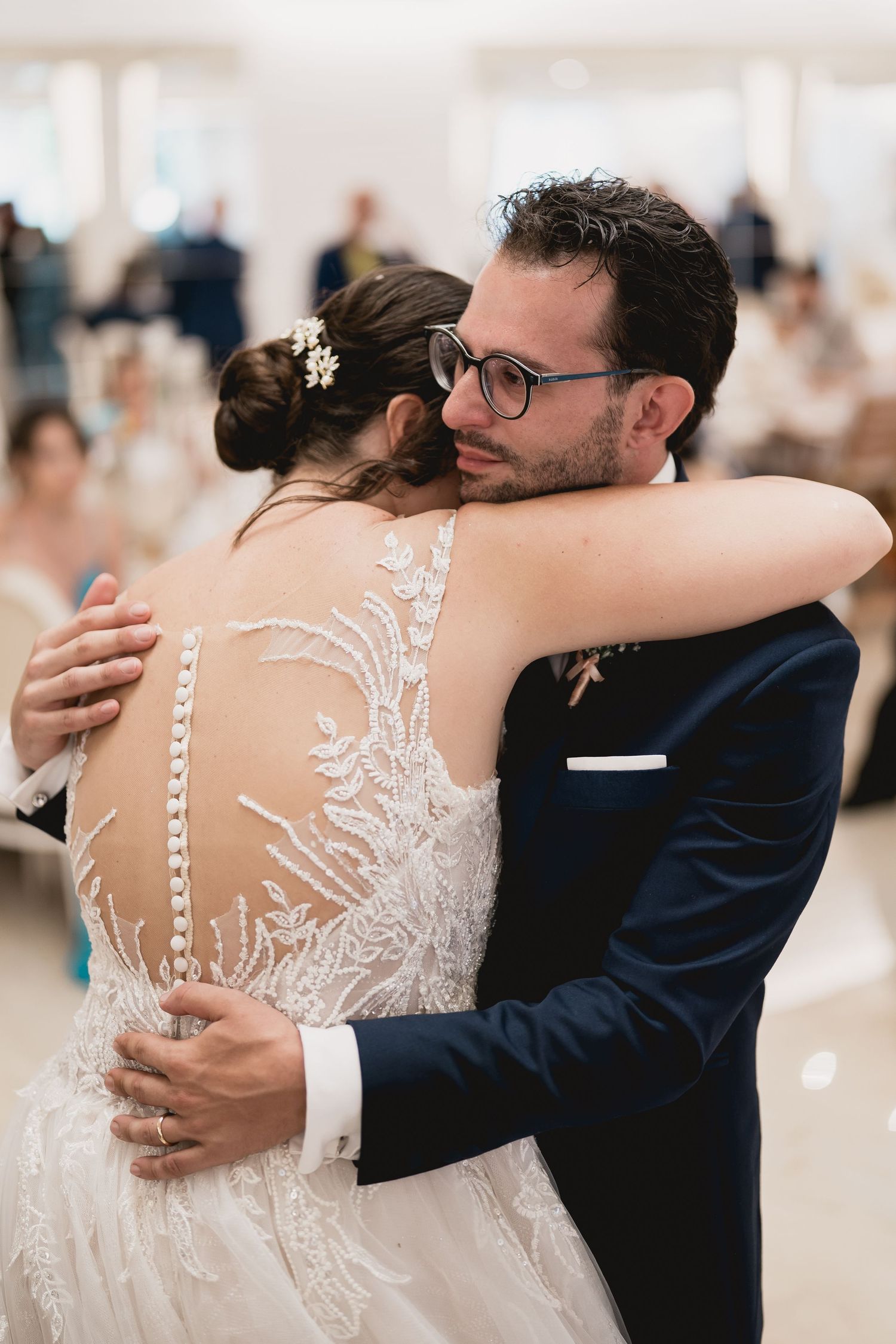 A close emotional embrace between newlyweds during their wedding dance.