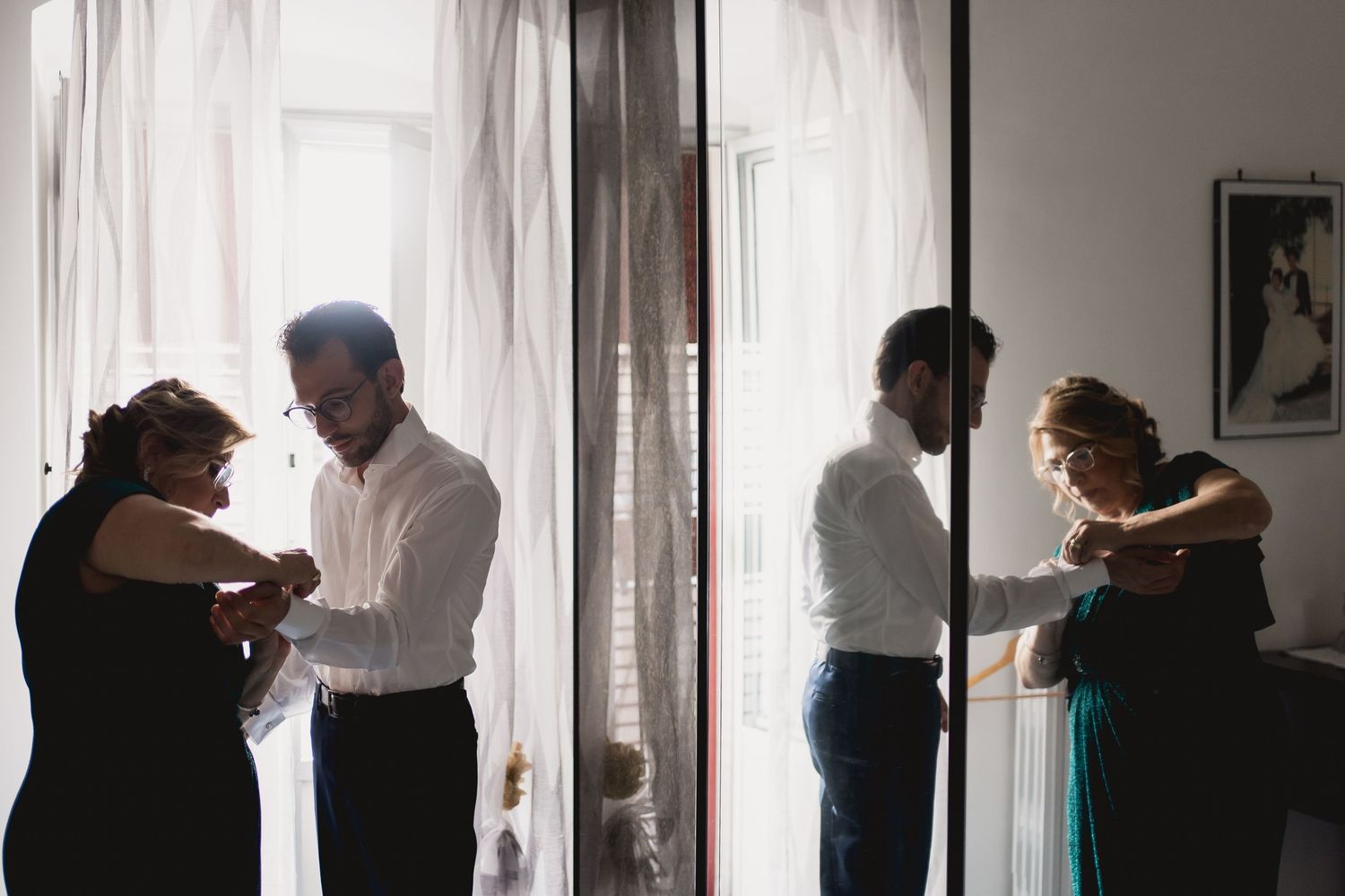 Two couples dancing together in a sunlit room near windows.