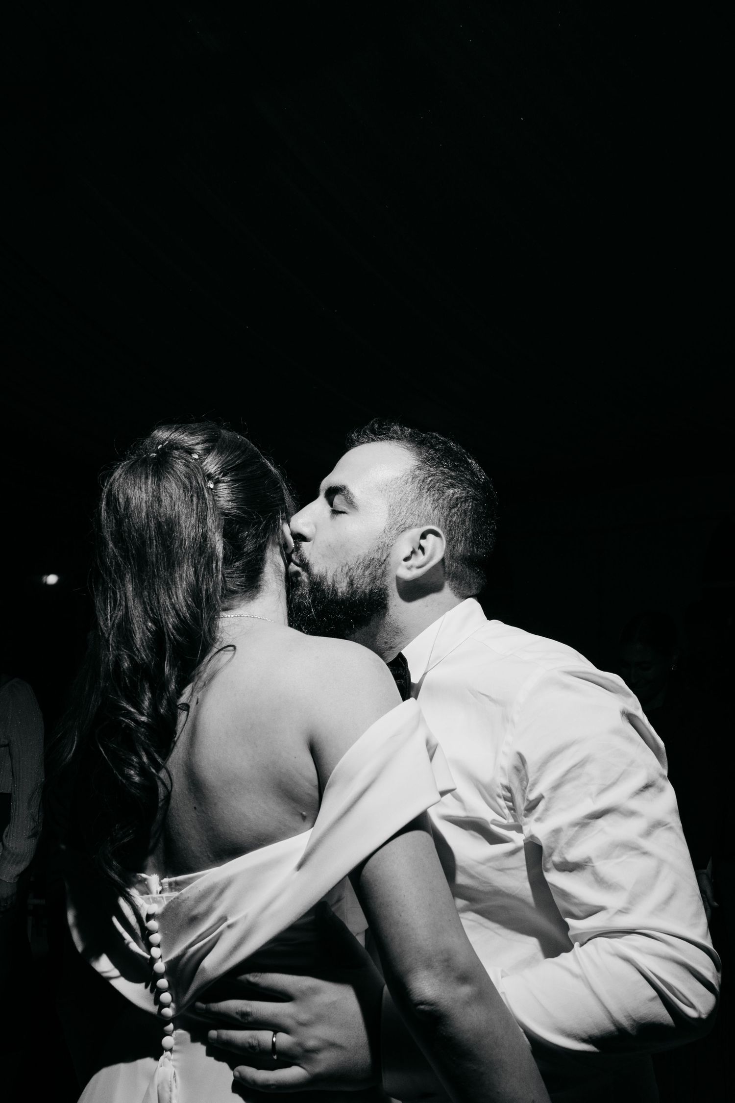 Black and white intimate dance photos showing romantic moments in dramatic lighting.