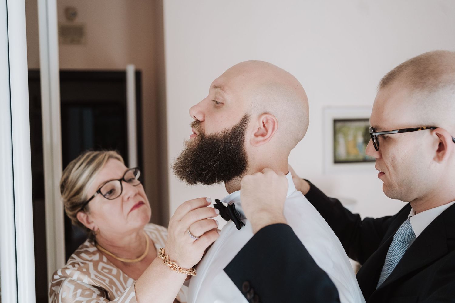 Wedding preparation moment with final touches being made to formal attire.