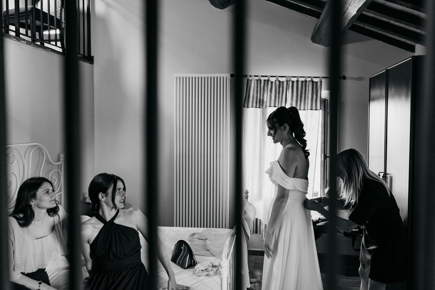 Black and white photo of wedding preparations in a sunlit room.