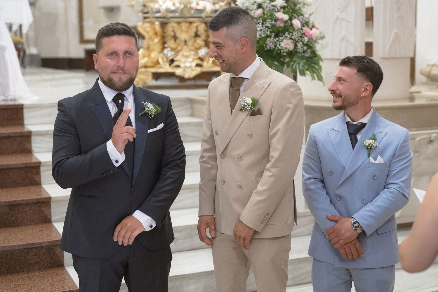 Groomsmen in suits having an animated conversation before the ceremony.