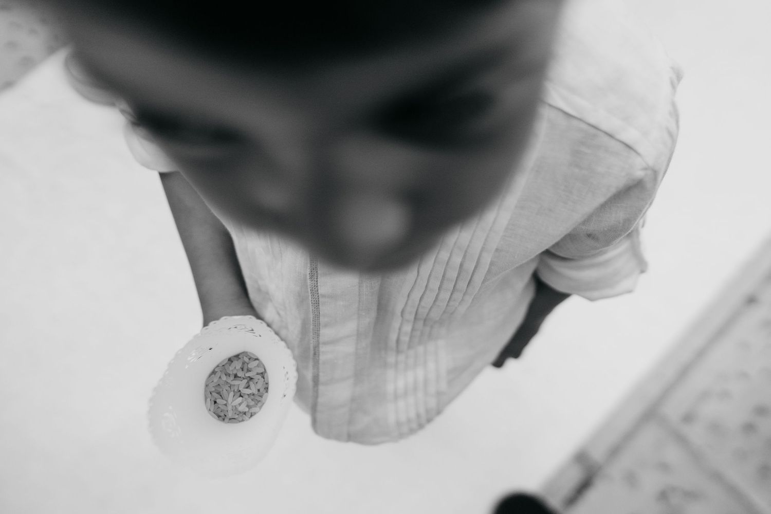 Close-up detail shot of wedding dress fabric and buttons in black and white.