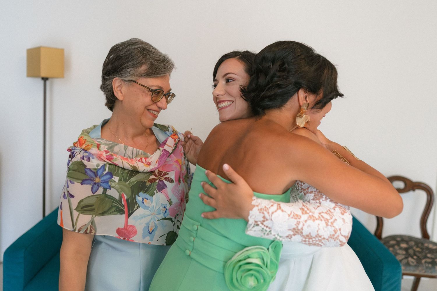 Wedding attendees embrace during emotional celebration moment.