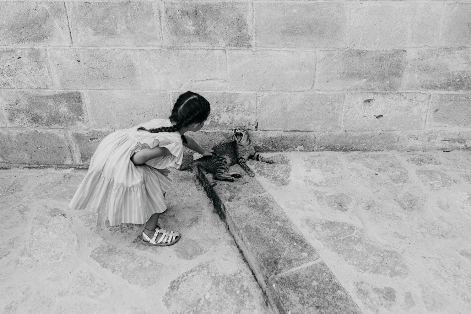 Artistic black and white wedding photography on stone floor.