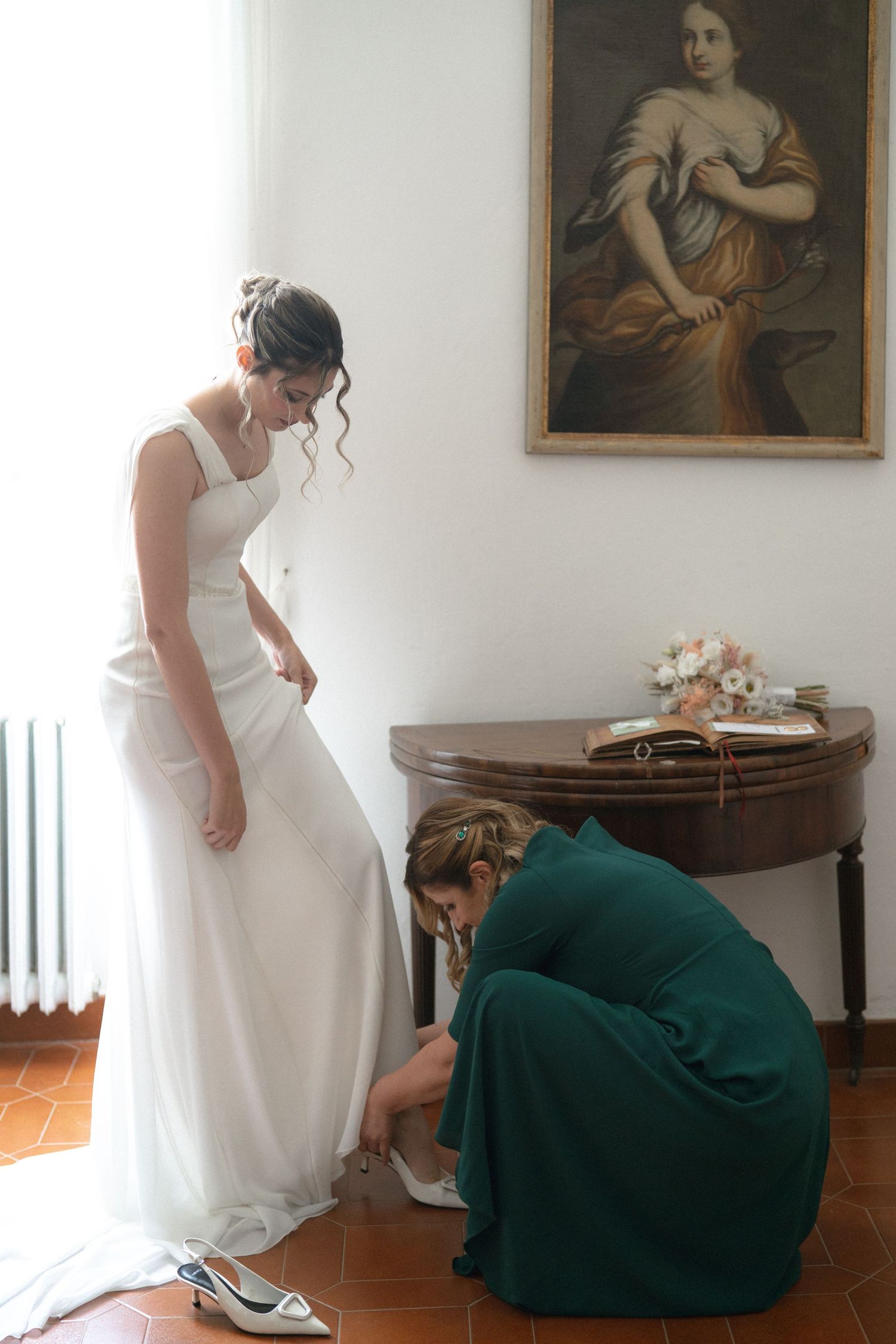 A sequence showing someone in a white dress getting ready with assistance in an elegant room with antique furniture.