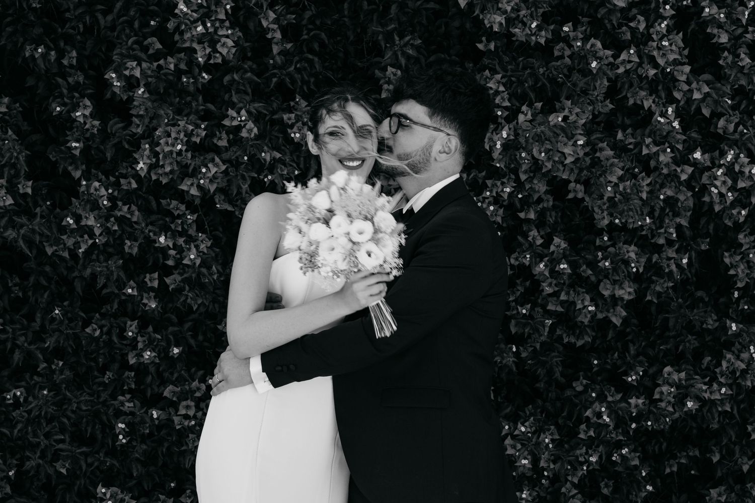 Black and white wedding photos showing intimate moments against a garden backdrop.