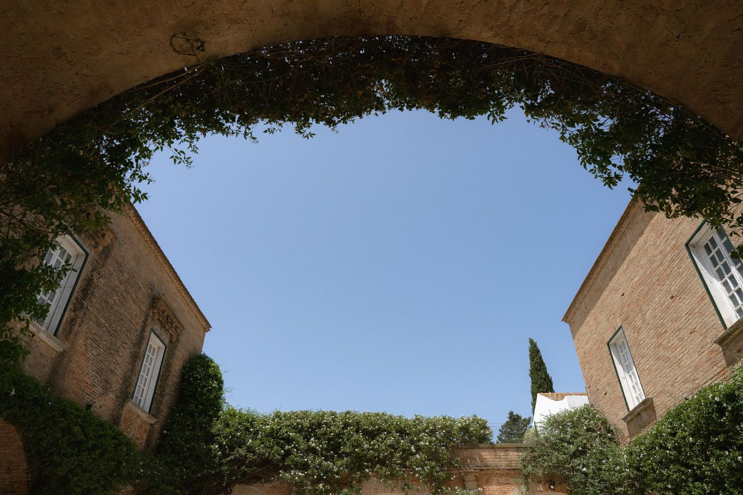 Architectural details of a historic building with brick walls and blue sky.