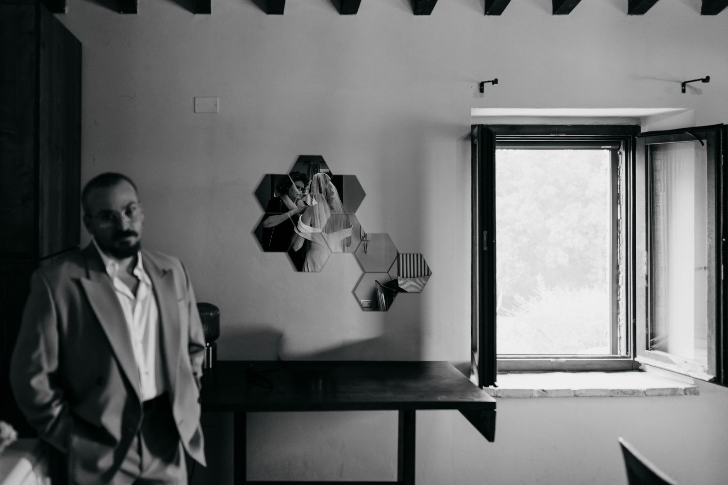 Modern interior with window light casting dramatic shadows in black and white photography.