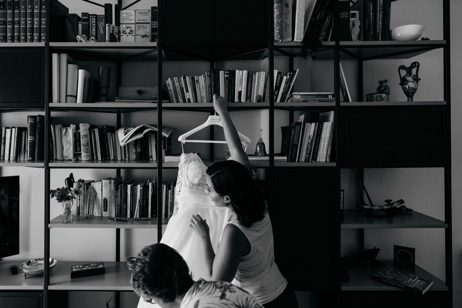 A collection of black and white photographs showing people working at desks in an office or library setting.