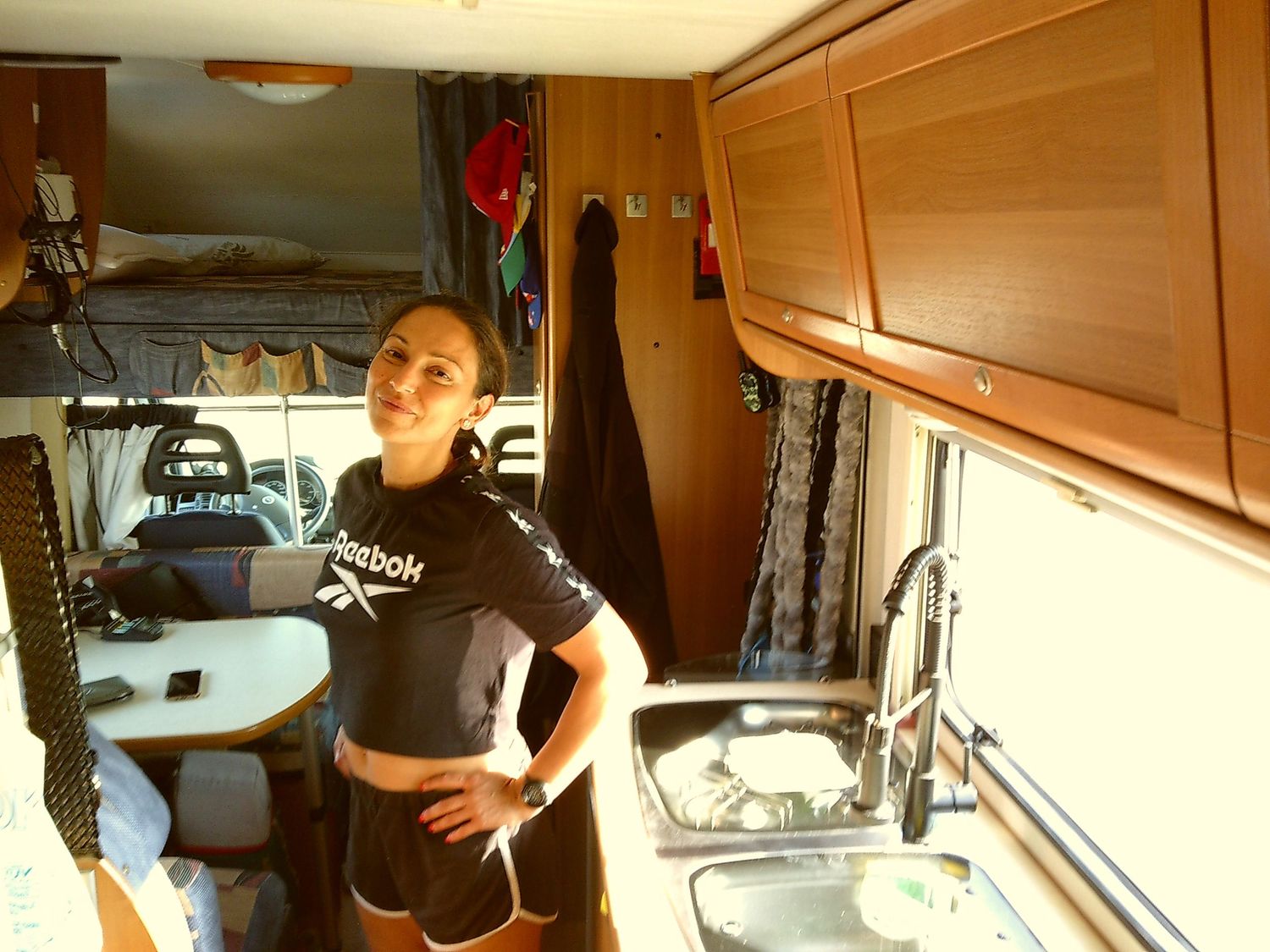 Interior view of a camper van showing storage cabinets and living space.