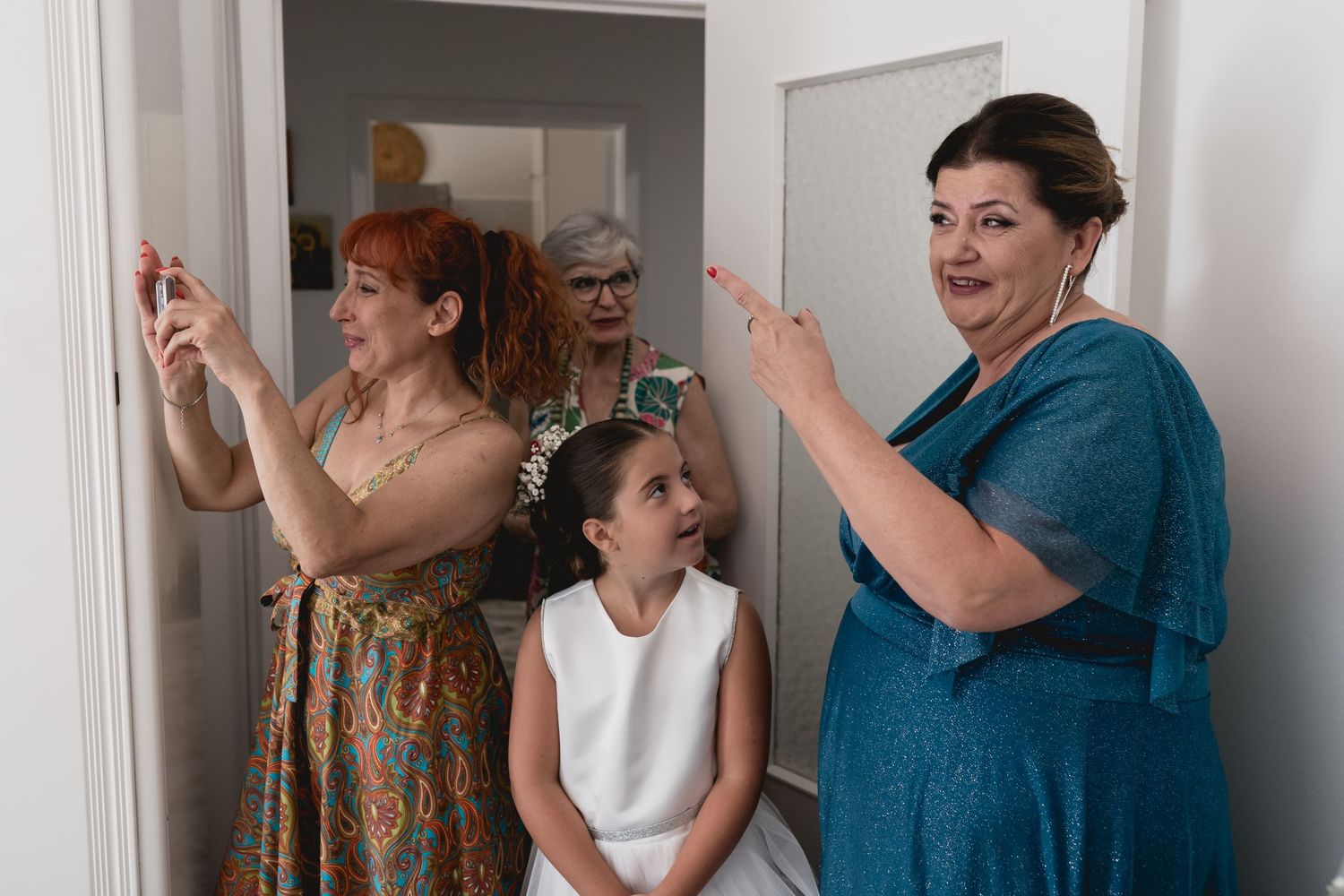 Emotional wedding morning scene with group reactions in a bright interior setting.