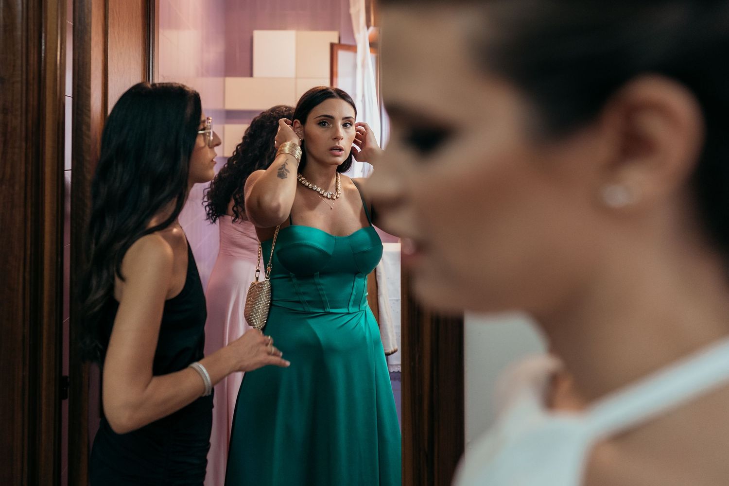 Wedding preparation scene with elegant teal bridesmaid dress in focus.