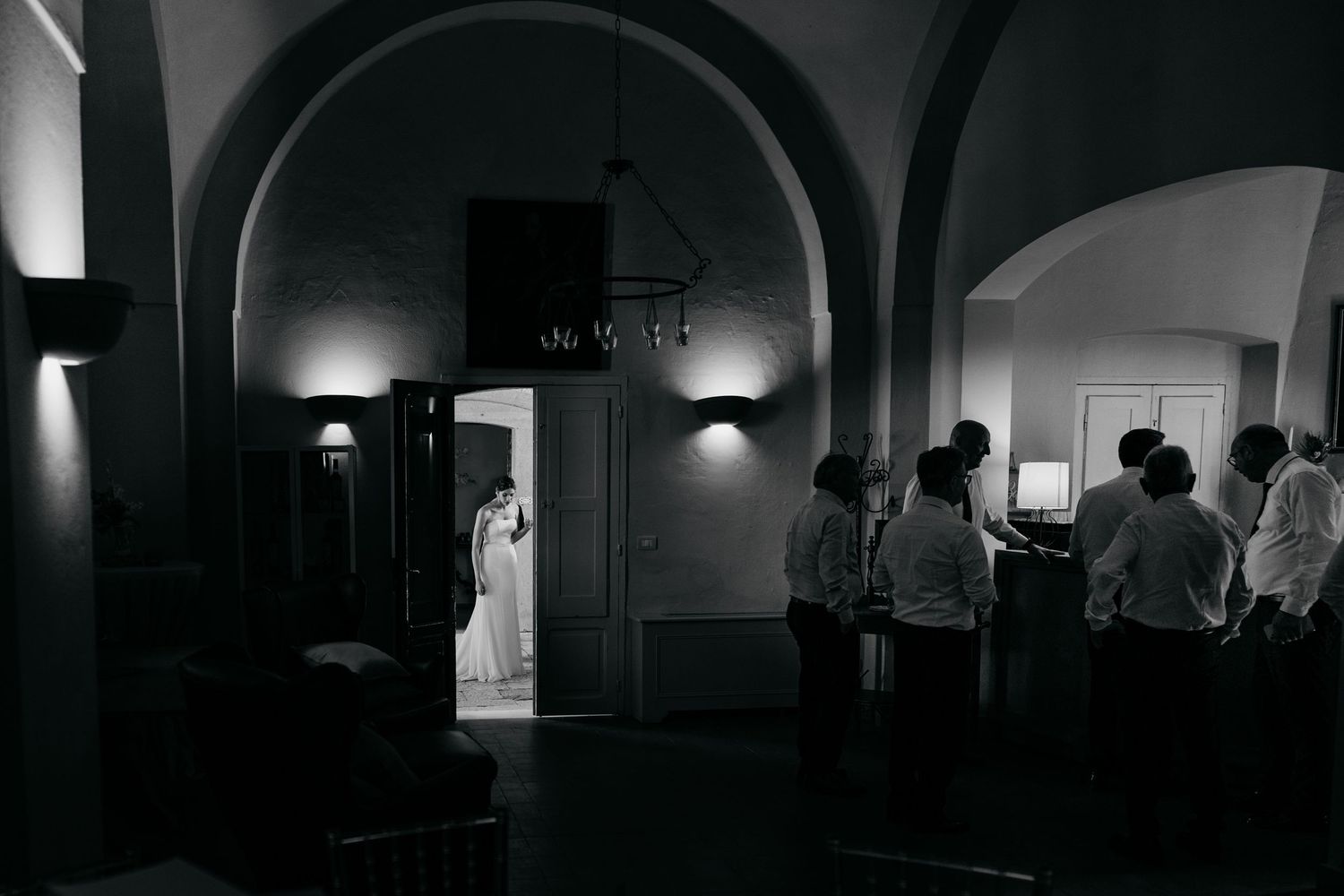 Dark architectural interior shots showing dramatic lighting and arched hallways.