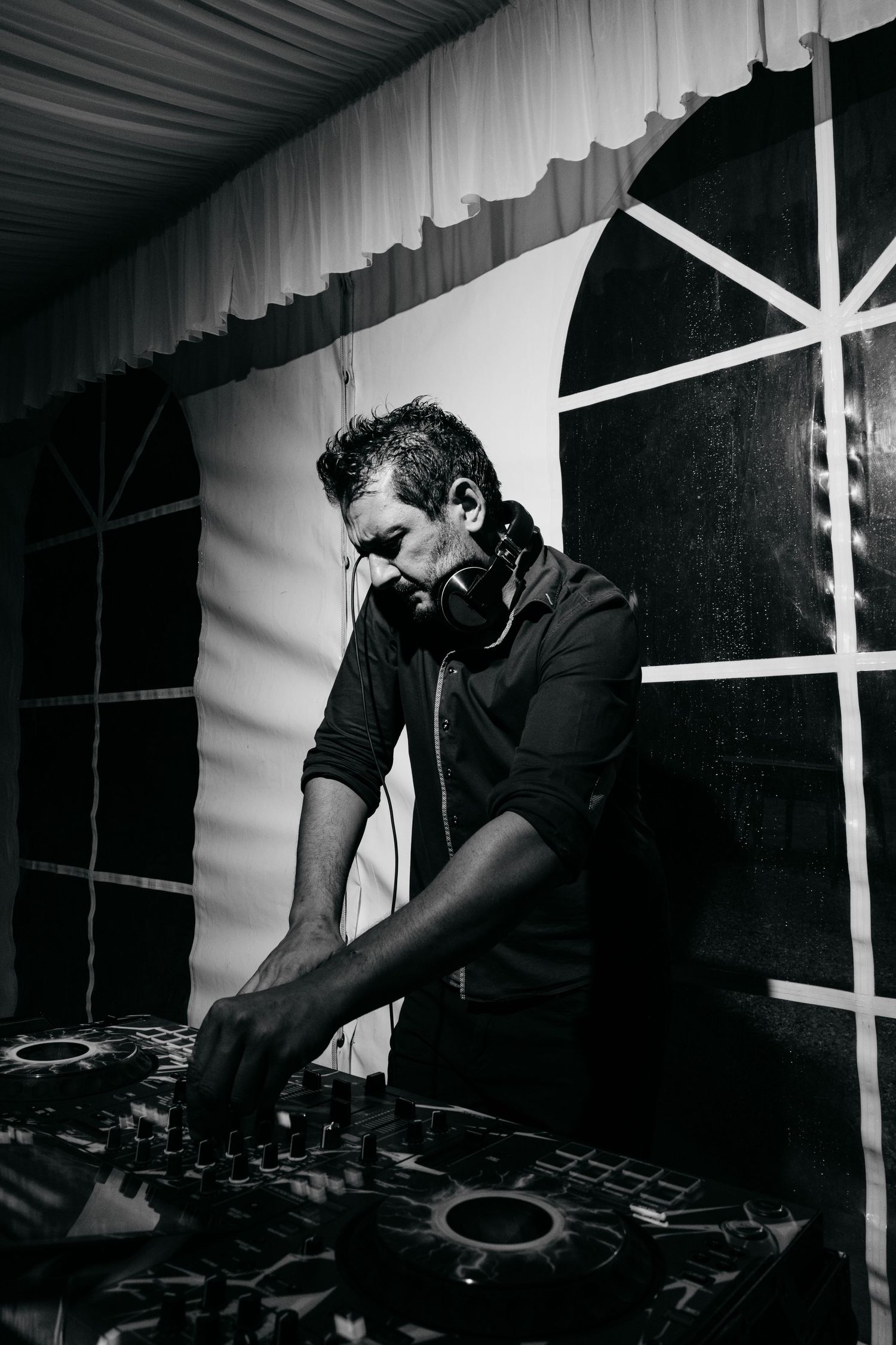 Black and white photo of DJ equipment being operated at an event.