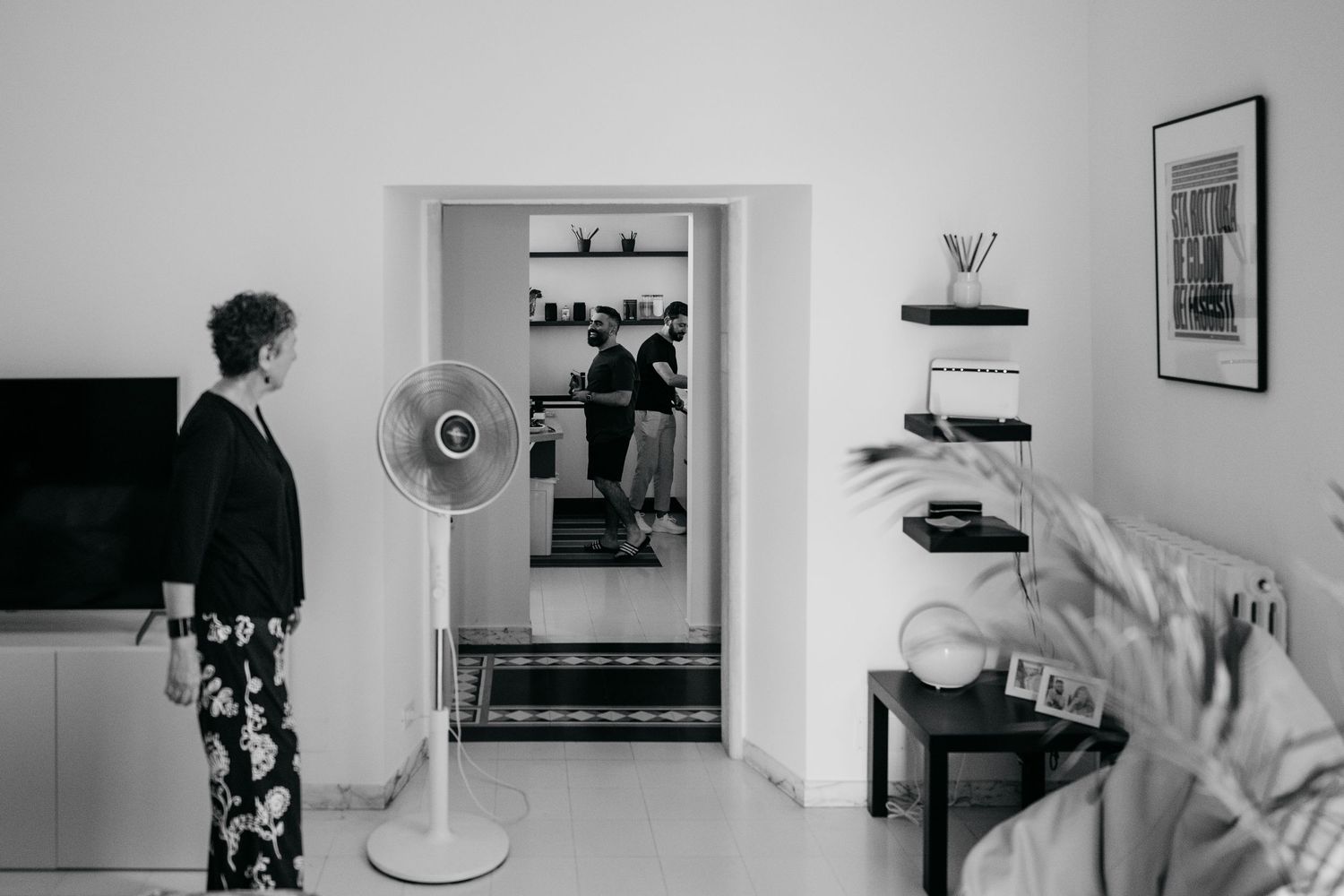Interior view of a modern room with standing fan and framed artwork.