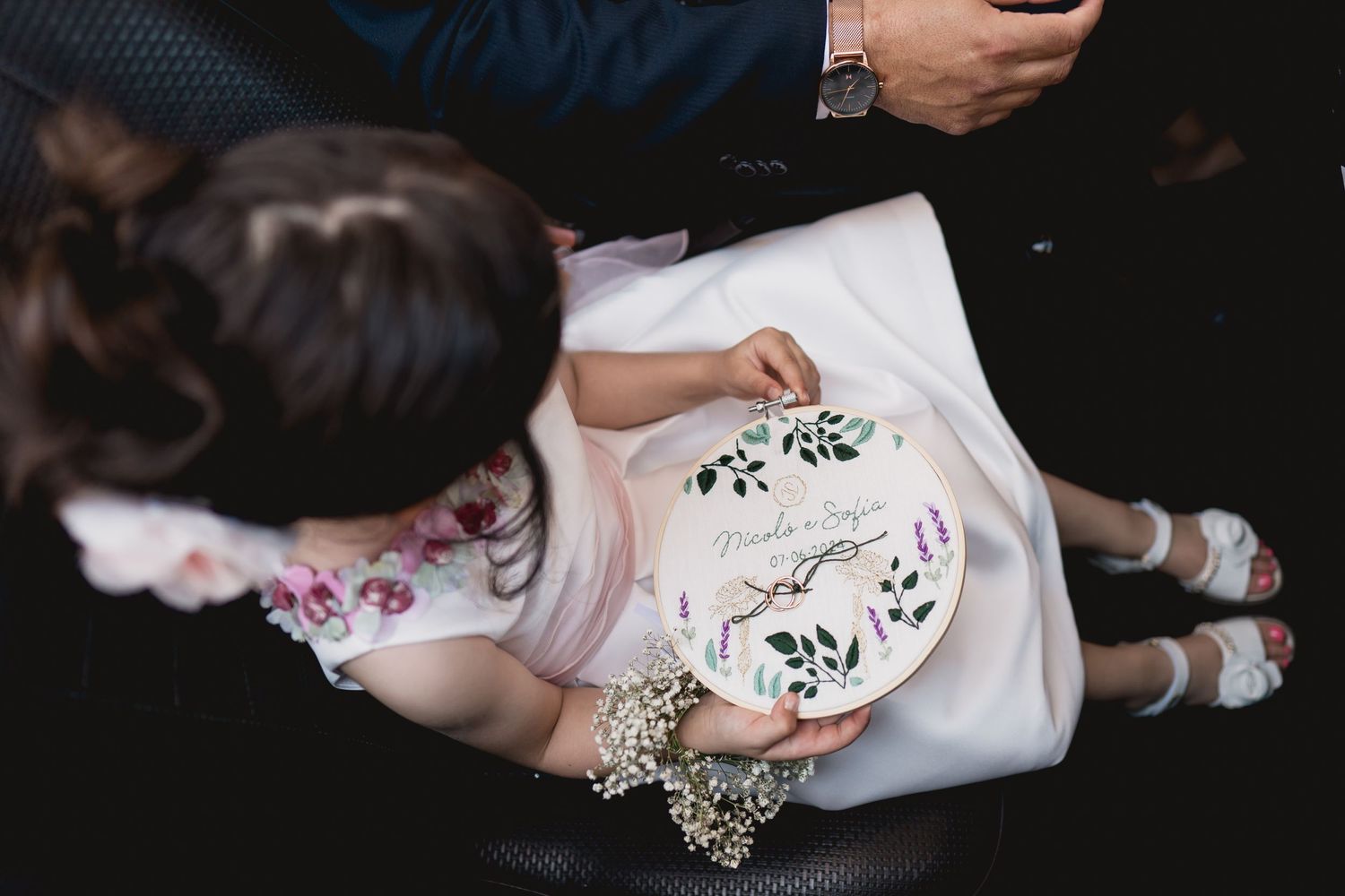 Wedding dress detail with delicate floral embroidery hoop design.
