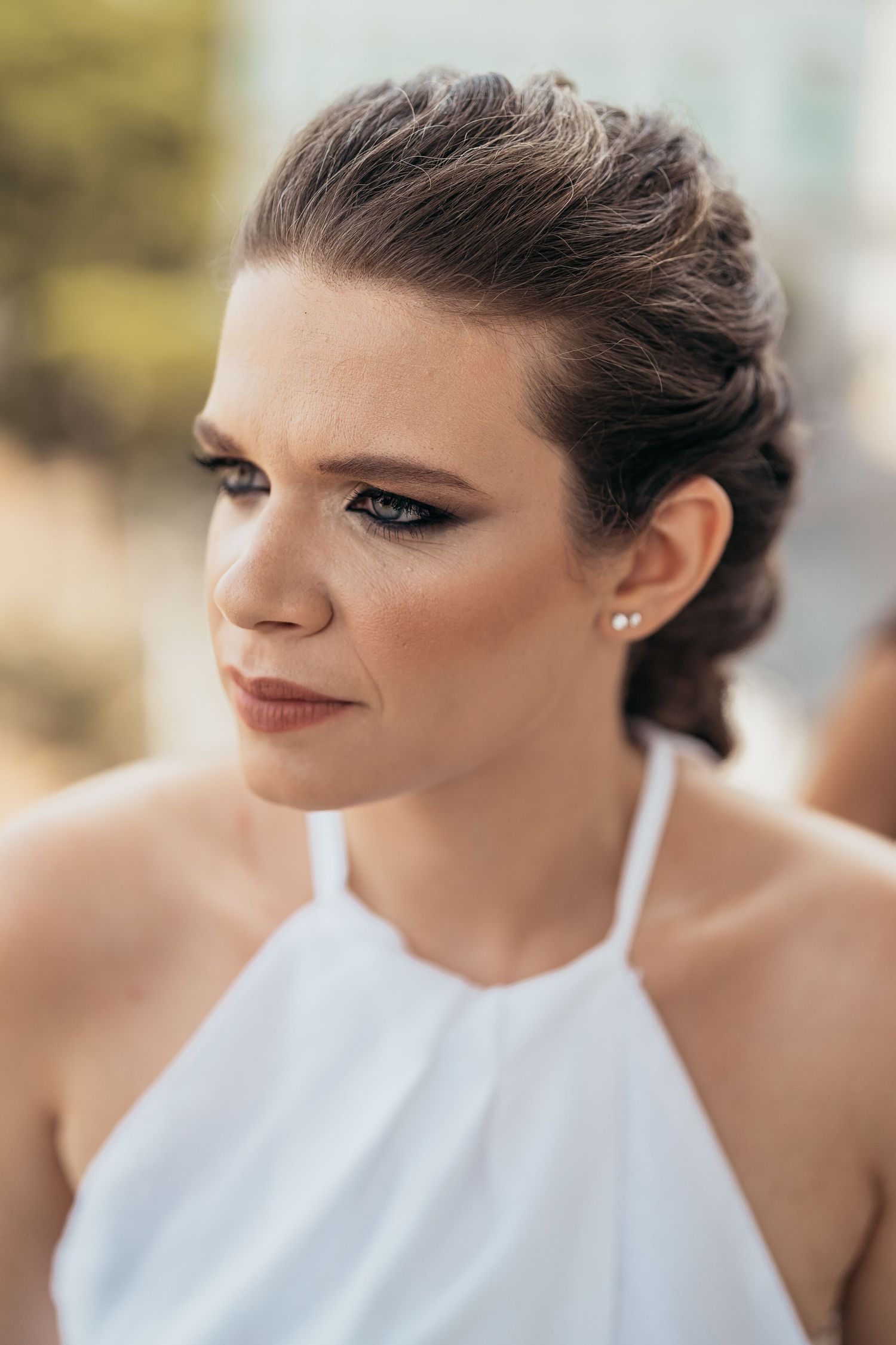 Elegant bridal portrait featuring halter neckline dress and sophisticated updo.