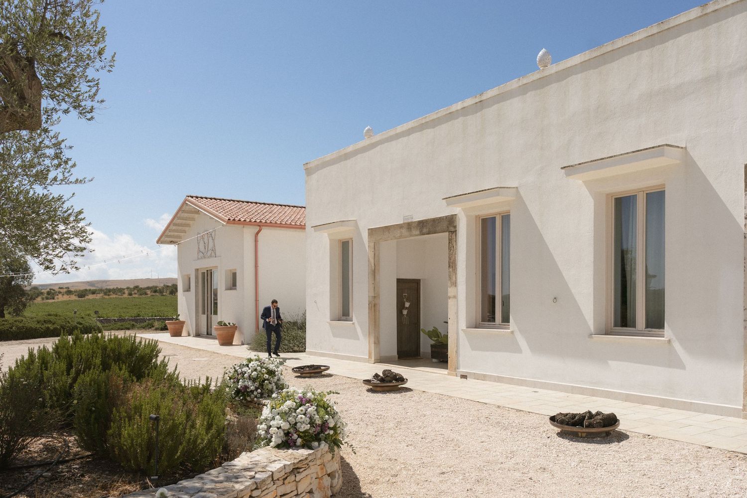 Modern white Mediterranean style building exterior with clean architectural lines.