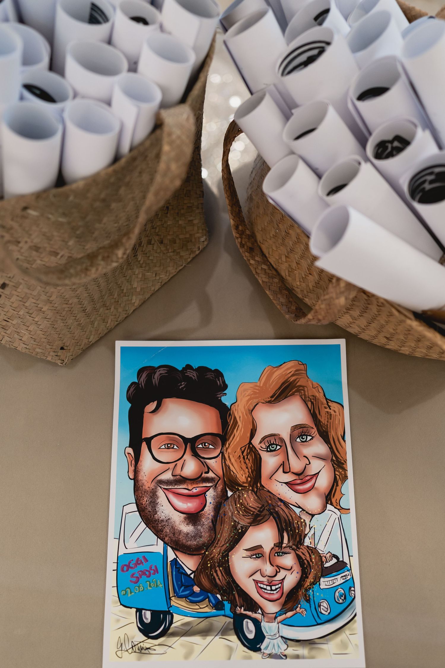 Caricature drawing displayed next to rolled paper programs in woven baskets.