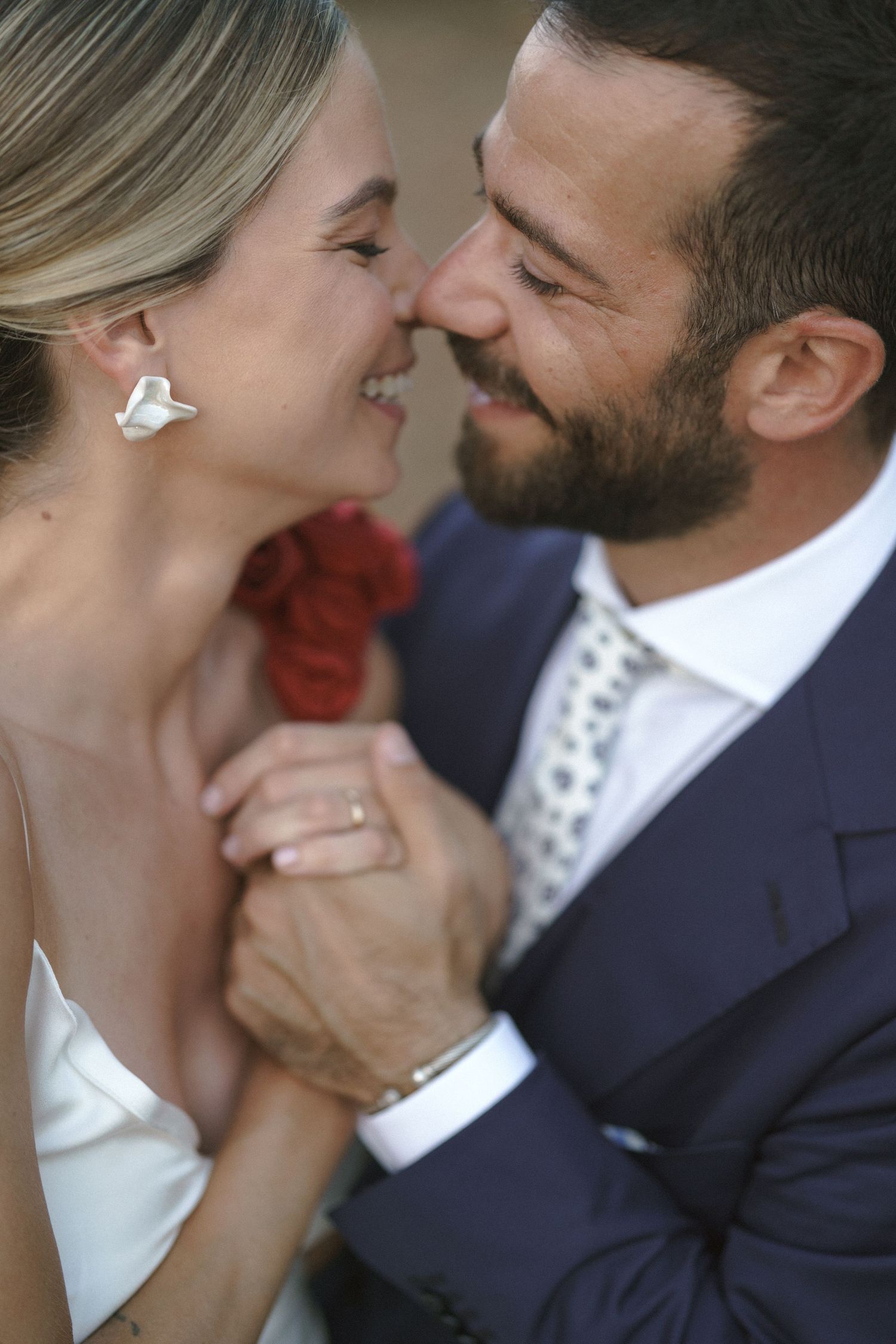 A romantic close-up moment between newlyweds sharing laughter and joy.
