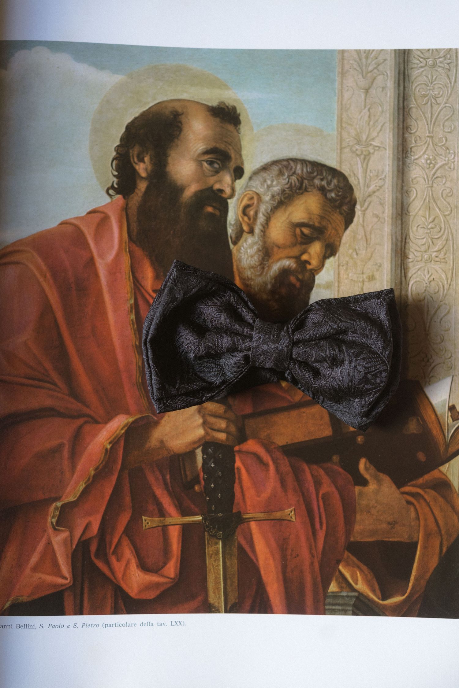 A classical religious artwork depicting figures in red robes seated together.