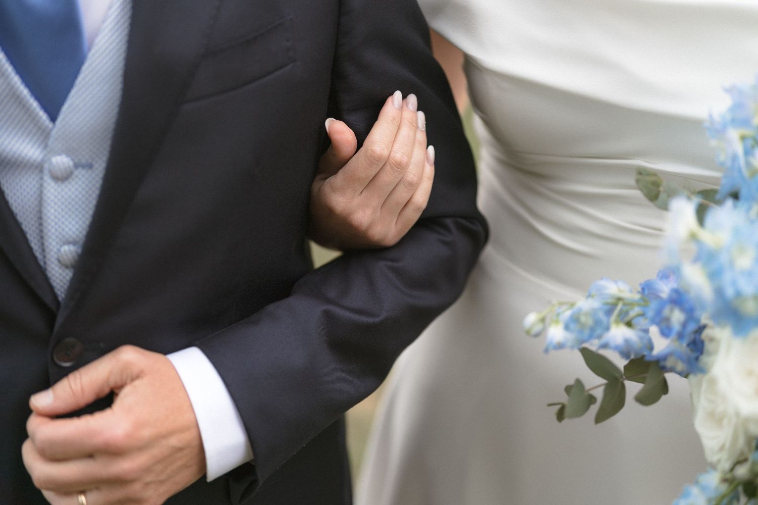 Close-up details of wedding attire showing formal wear in soft natural light.