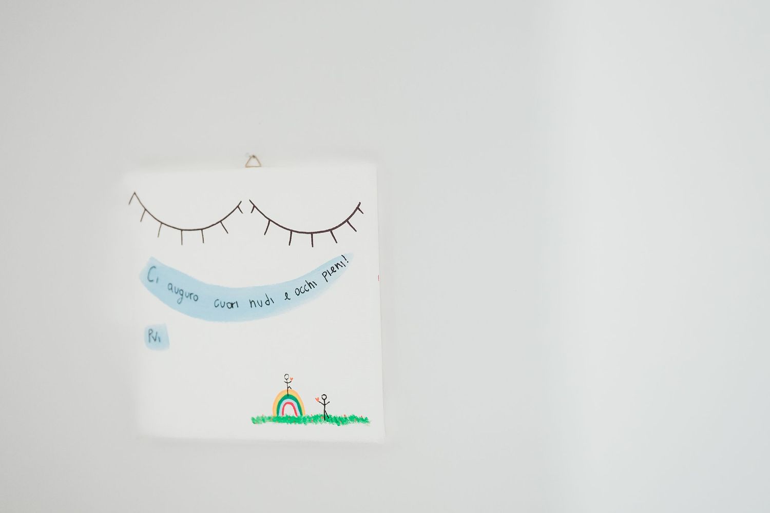 Minimalist drawing of closed eyes and small landscape on white background.